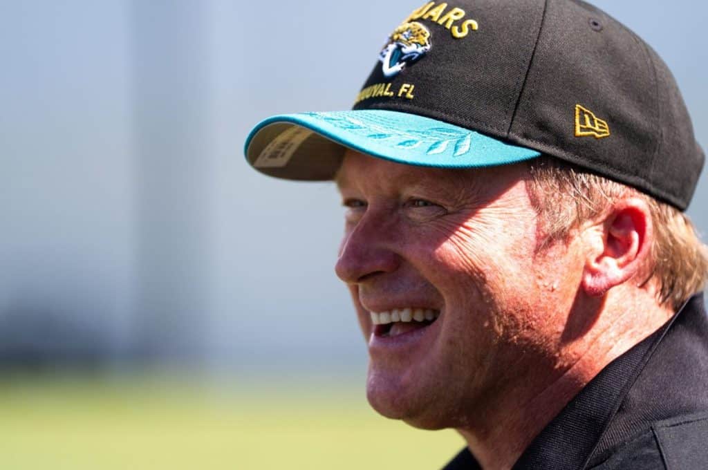 Former NFL Coache Jon Gruden have a laugh while attending an NFL training camp session ten at the Miller Electric Center,