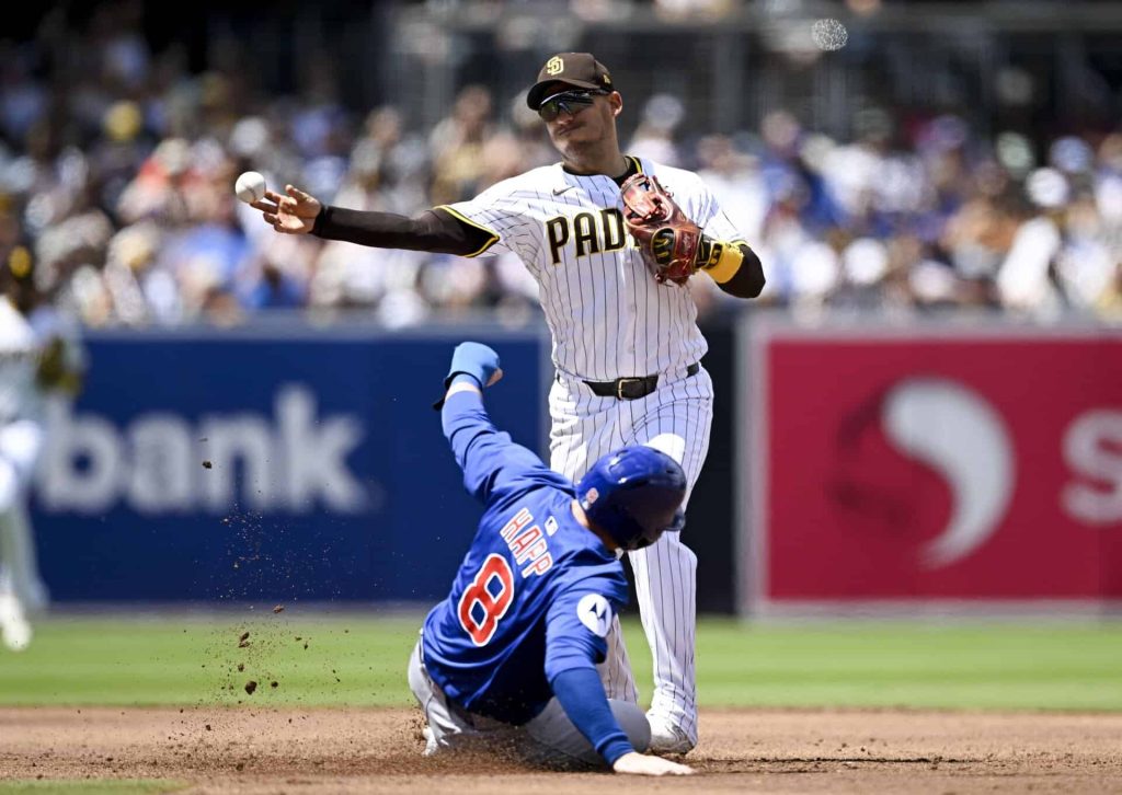 Padres second baseman Jose Iglesias turns a double play over Cubs left fielder Ian Happ at Petco Park in 2025, file photo for Padres beat Cubs Wild Card sweep