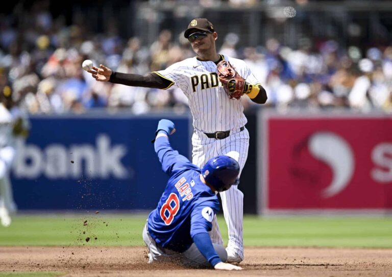 Padres second baseman Jose Iglesias turns a double play over Cubs left fielder Ian Happ at Petco Park in 2025, file photo for Padres beat Cubs Wild Card sweep