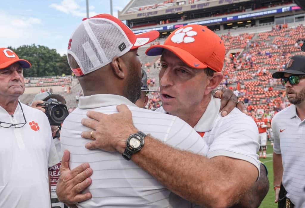 Syracuse coach Fran Brown and Clemson coach Dabo Swinney meet at half field