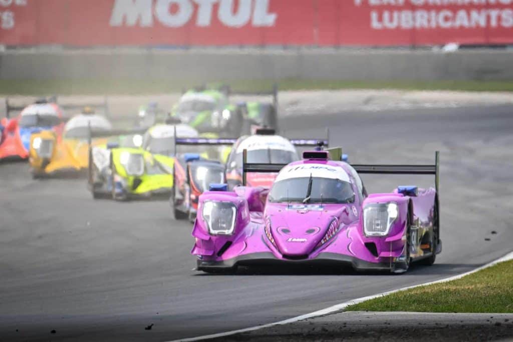 The LMP2 AO Racing ORECA of PJ Hyett and Dane Cameron (99) leads a pack of cars into the Carousel in the IMSA Motul