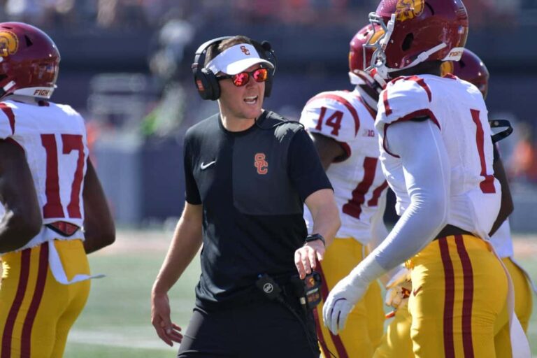 Washington vs. USC: USC coach Lincoln Riley talks with players during a September 2025 game at Illinois