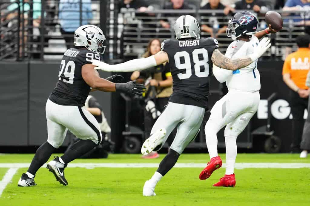 Las Vegas Raiders defensive end Maxx Crosby closes in on Titans QB Cam Ward Image by: Stephen R. Sylvanie-Imagn Images