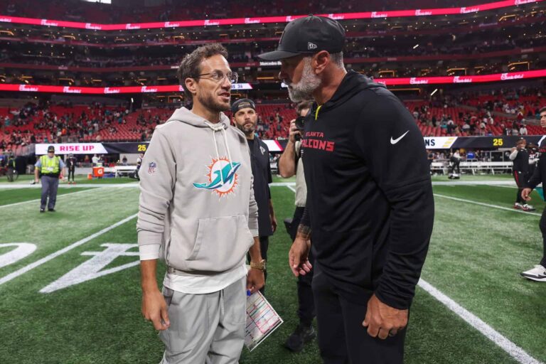 Mike McDaniel, then Miami Dolphins head coach, talks with Falcons coordinator Jeff Ulbrich after an October 2025 game