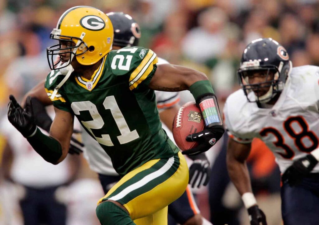 Green Bay Packers cornerback Charles Woodson returns a punt 12 yards during the fourth quarter of their game against the