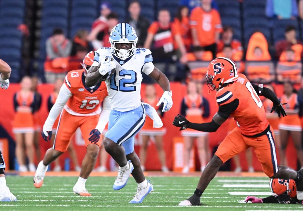 North Carolina Tar Heels running back Demon June (12) avoids a tackle by Syracuse Orange defensive back Braheem Long Jr. (0) to score a touchdown in the third quarter. Image by: Mark Konezny-Imagn Image