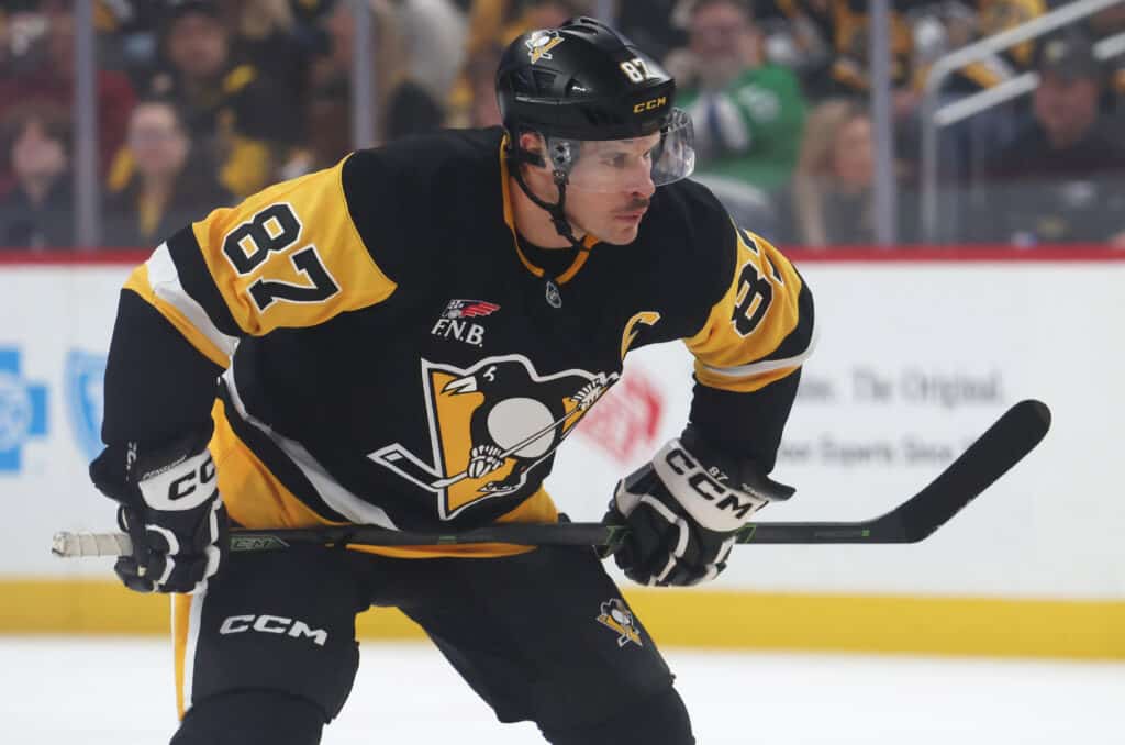 Penguins center Sidney Crosby waits for a faceoff in Pittsburgh; Crosby had an assist as the Penguins beat Flyers 7-0 in the 2026-27 opener
