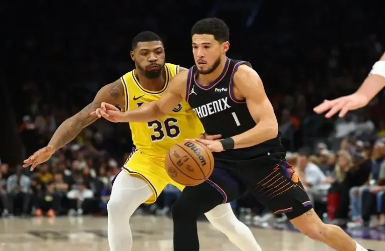 Phoenix Suns guard Devin Booker (1) against Los Angeles Lakers guard Marcus Smart (36) in the first half at Mortgage Matchup Center.