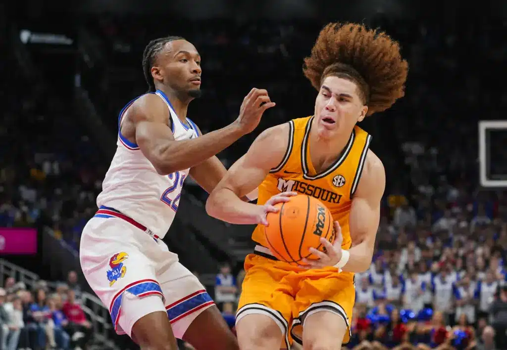 NBA Draft; Dec 7, 2025; Kansas City, Missouri, USA; Missouri Tigers guard T.O. Barrett (5) drives against Kansas Jayhawks guard Darryn Peterson (22) during the second half at T-Mobile Center. Mandatory Credit: Jay Biggerstaff-Imagn Images