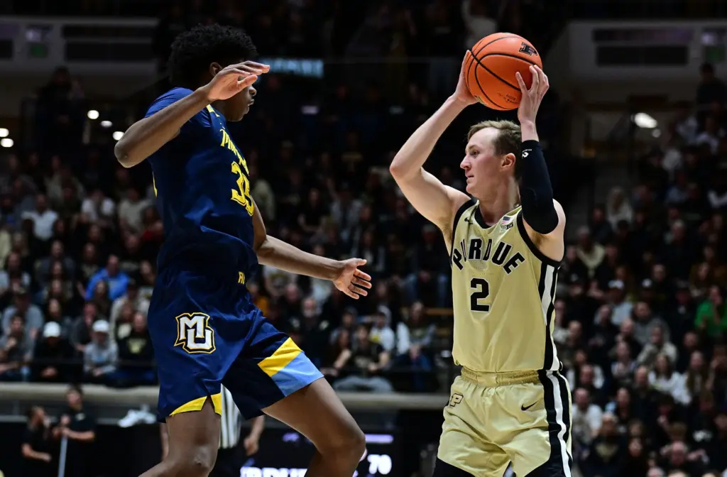 Dec 13, 2025; West Lafayette, Indiana, USA; Purdue Boilermakers guard Fletcher Loyer (2) looks pass against Marquette Golden Eagles forward Michael Phillips II (35) during the second half at Mackey Arena. Mandatory Credit: Marc Lebryk-Imagn Images