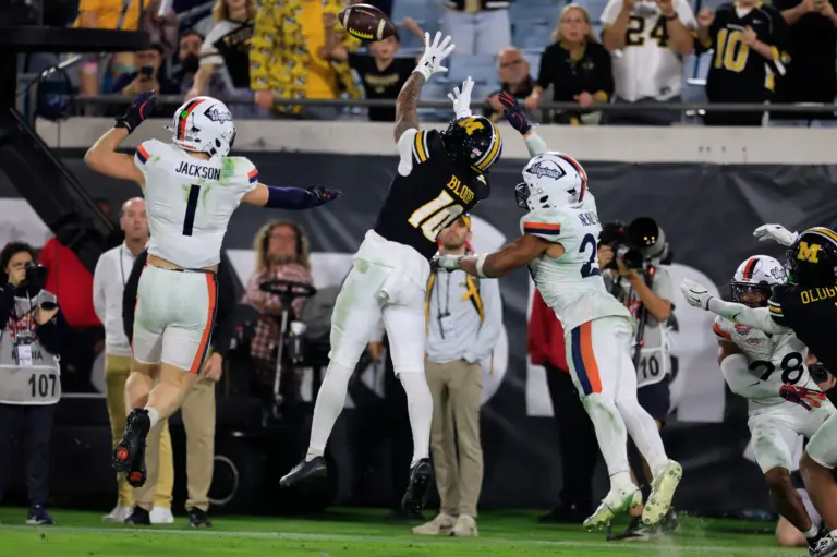Missouri Tigers wide receiver Daniel Blood (10) can’t haul in a reception against Virginia Cavaliers safety Devin Neal (27) as linebacker James Jackson (1) looks on during the fourth quarter of the TaxSlayer Gator Bowl at EverBank Stadium, Saturday, Dec. 27, 2025, in Jacksonville. Fla. Virginia defeated the Missouri 13-7. [Corey Perrine/Florida Times-Union]
