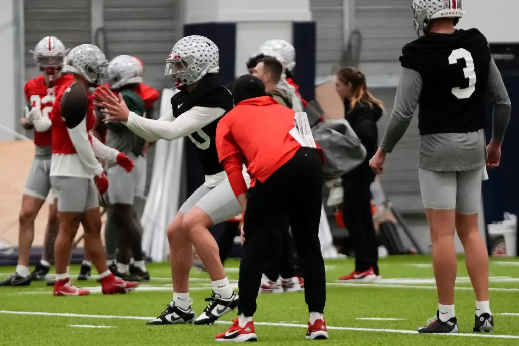 Ohio State Buckeyes quarterback Julian Sayin (10) takes a snap during practice at Highland Park High School in Dallas prior to the College Football Playoff matchup against the Miami (FL) Hurricanes on Dec. 29, 2025.