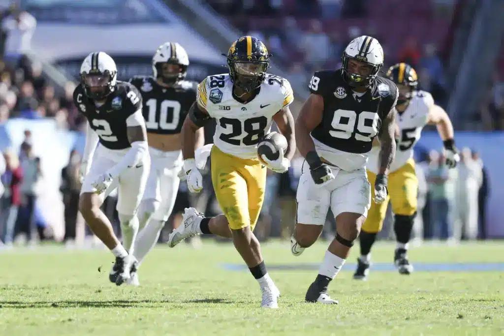 Dec 31, 2025; Tampa, FL, USA; Iowa Hawkeyes running back Kamari Moulton (28) runs with the ball against the Vanderbilt Commodores in the third quarter during the ReliaQuest Bowl at Raymond James Stadium. Mandatory Credit: Nathan Ray Seebeck-Imagn Images