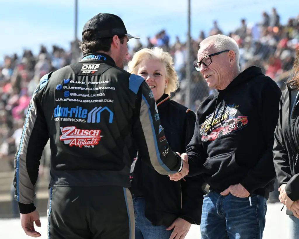 NASCAR Hall of Famer Mark Martin, serving as grand marshal for the ASA Midwest Tour Joe Shear Classic, shakes hands with Luke Fenhaus during driver introductions Sunday, May 4, 2025, at Madison International Speedway in Town of Rutland, Wisconsin.