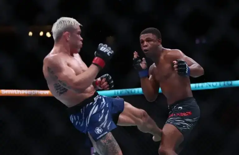 Ricky Simon (red gloves) fights Cameron Smotherman (blue gloves) during UFC Fight Night at State Farm Arena