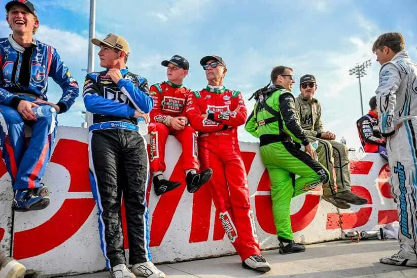 Former NASCAR Cup Series champion Kevin Harvick, center, right, and his son Keelan, 13, look on before the two raced in the 13th annual Masters of the Pros 200 race on Wednesday, July 16, 2025, at the Owosso Speedway.