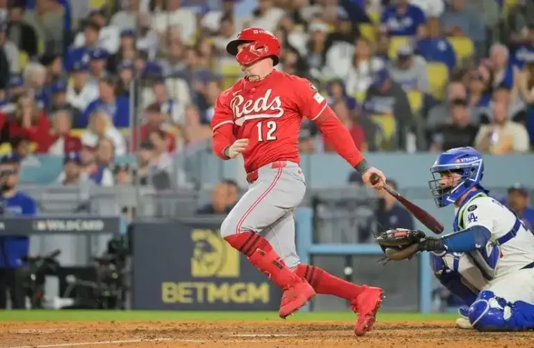 Cincinnati Reds left fielder Austin Hays (12) hits a single during the seventh inning against the Los Angeles Dodgers during game one of the Wildcard round for the 2025 MLB playoffs at Dodger Stadium