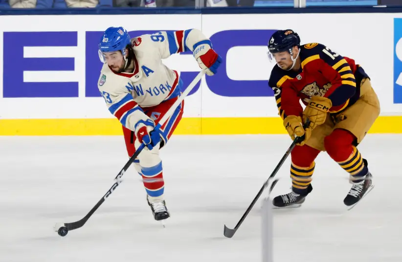 New York Rangers center Mika Zibanejad (93) passes the puck defended by Florida Panthers center Sam Reinhart (13) during the second period in the 2026 Winter Classic.