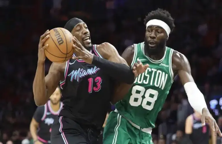 Boston Celtics center Neemias Queta (88) defends against Miami Heat center Bam Adebayo (13) during the first half at Kaseya Center