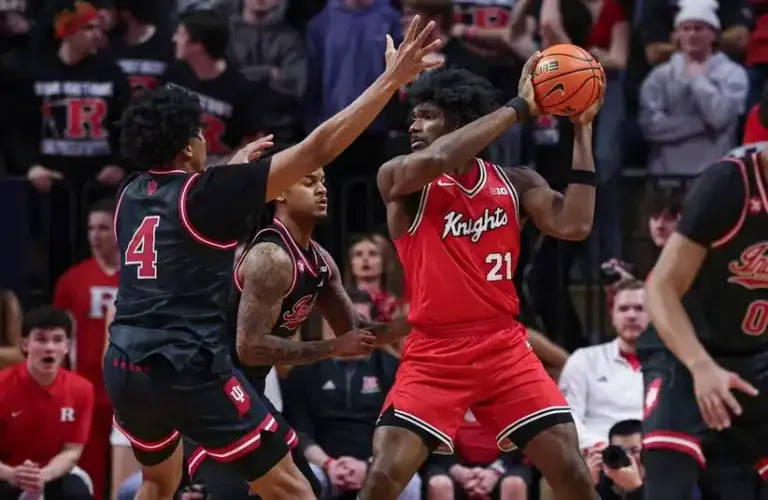 Rutgers Scarlet Knights center Emmanuel Ogbole (21) is guarded by Indiana Hoosiers guard Lamar Wilkerson (3) and forward Sam Alexis (4)