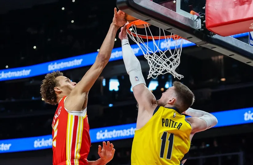 Atlanta Hawks guard Dyson Daniels (5) dunks the ball against Indiana Pacers center Micah Potter (11) during the first quarter at State Farm Arena.