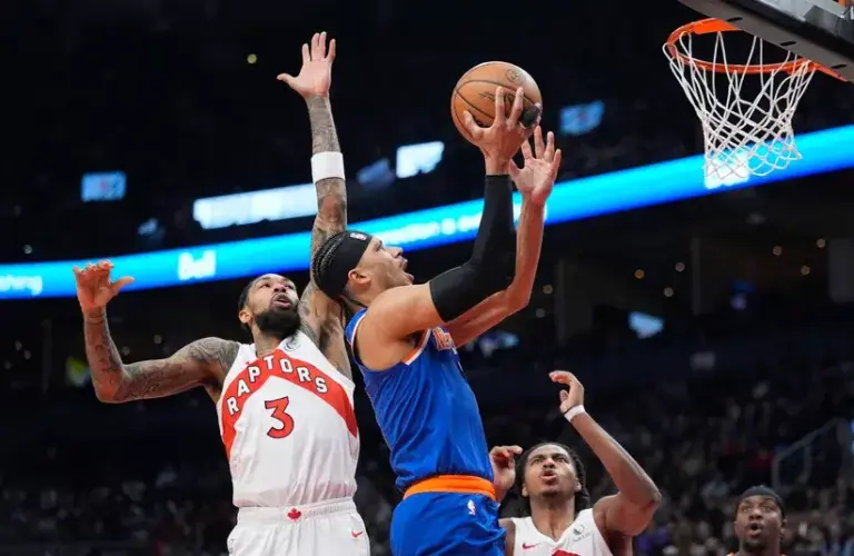 New York Knicks forward Josh Hart (3) goes up to make a basket against Toronto Raptors forward Brandon Ingram (3) during the first half.