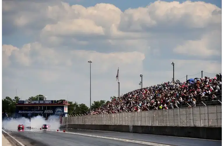 Sept. 10, 2011; Rockingham, NC, USA; ADRL fans watch from the grandstands as a pair of pro stock cars do their burnouts during eliminations at Dragstock 8 at Rockingham Dragway. Trial by Nitro