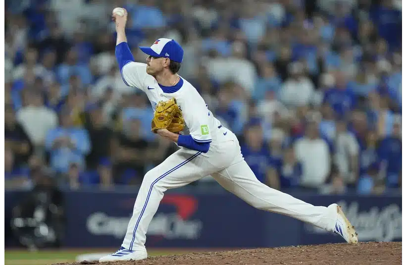Toronto Blue Jays pitcher Shane Bieber (57) pitches against the Los Angeles Dodgers in the eleventh inning during game seven of the 2025 MLB World Series at Rogers Centre.