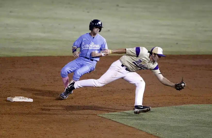 Jun 5, 2011; Chapel Hill, NC, USA; North Carolina outfielder Ben Bunting (3) comes safely into second base as James Madison infielder Bradley Shaban (7) reaches for the ball during the 8th inning of the Chapel Hill regional of the 2011 NCAA baseball tournament at Boshamer Stadium.