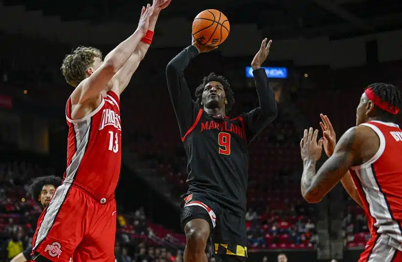Feb 5, 2026; College Park, Maryland, USA; Maryland Terrapins forward Solomon Washington (9) shoots as Ohio State Buckeyes center Christoph Tilly (13) and forward Amare Bynum (1) defends during the second half at Xfinity Center.