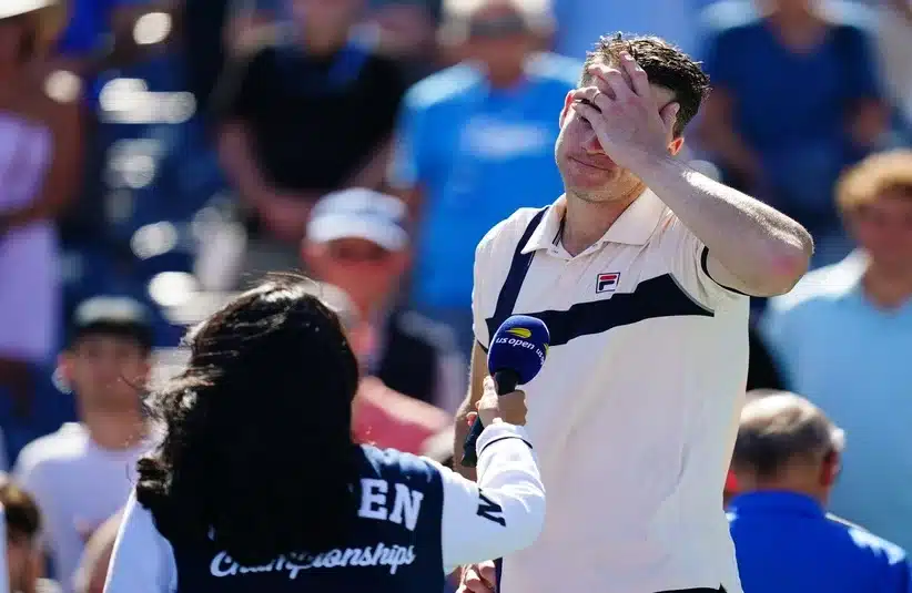 Isner having hand on his face