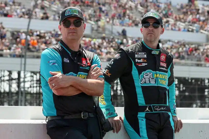 Spire; Jul 14, 2024; Long Pond, Pennsylvania, USA; NASCAR Cup Series driver Denny Hamlin (right) stands with his crew chief Chris Gabehart (left) on pit road prior to The Great American Getaway 400 at Pocono Raceway.