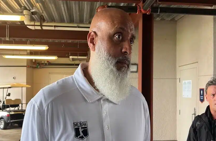 MLB Players Association executive director Tony Clark talks to reporters