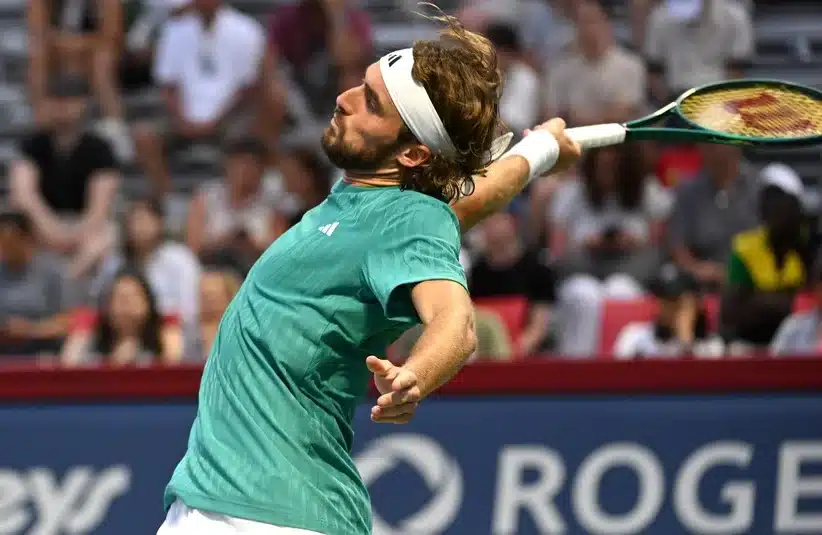 Tsitsipas hitting a backhand