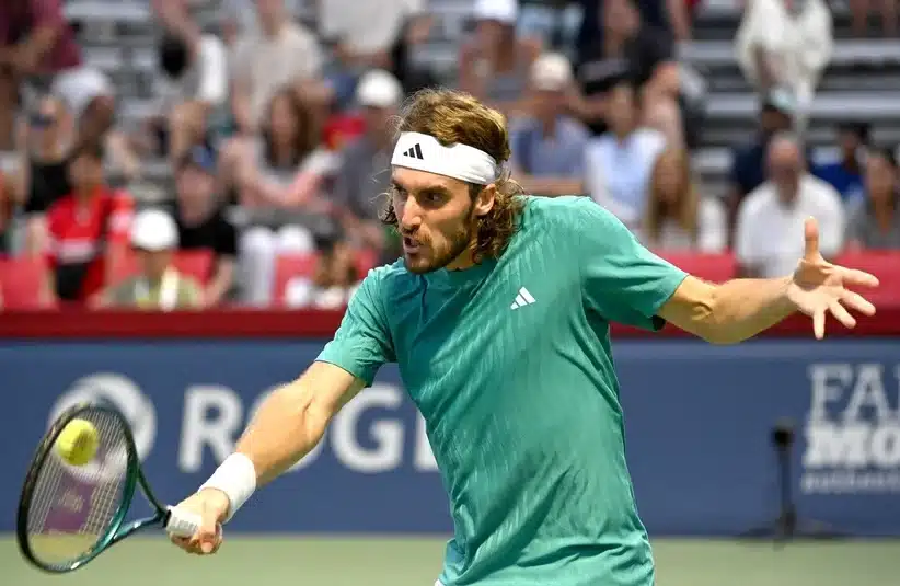 Tsitsipas hitting a backhand