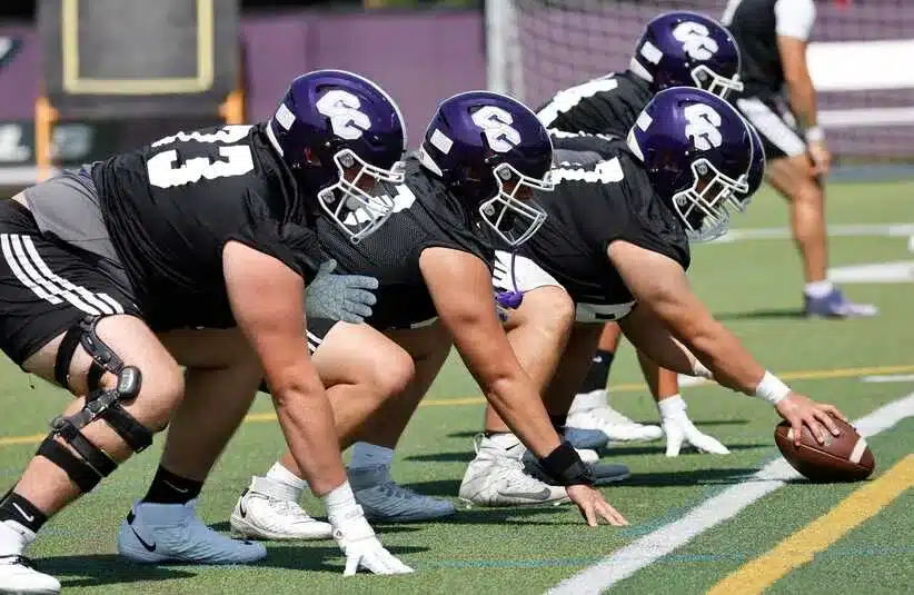 The offensive linemen practice their special teams formation. The Curry College Colonels football team starts practicing for the new season on Wednesday August 13, 2025