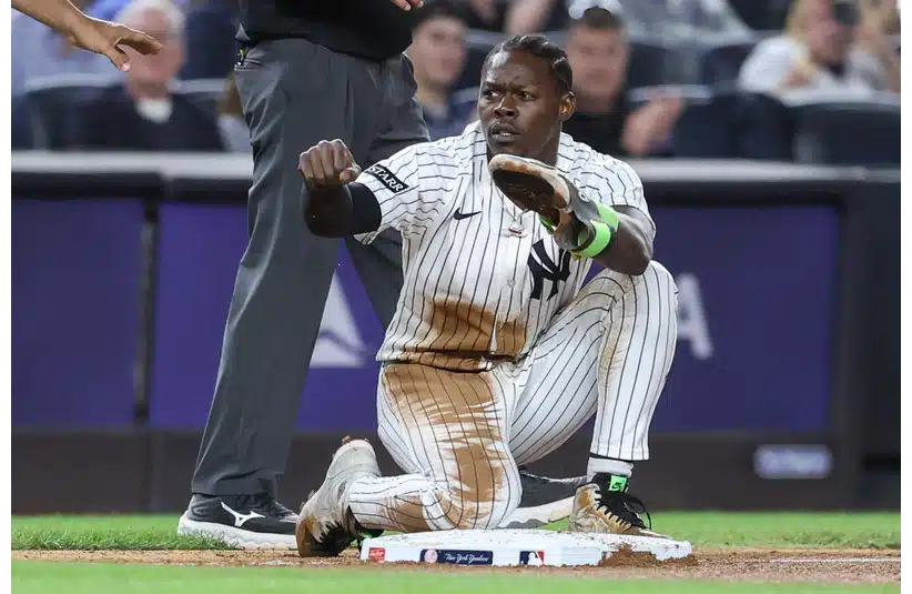 Jazz Chisholm gestures after sliding safely