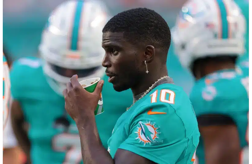 Tyreek Hill watches from the sideline