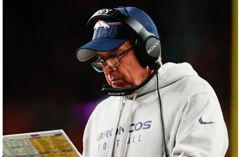 Broncos head coach Sean Payton looks at his notes during the third quarter against the Bengals