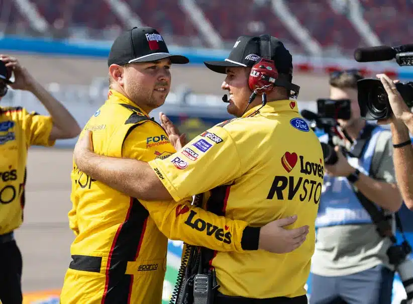 Oct 31, 2025; Avondale, Arizona, USA; NASCAR Truck Series driver Layne Riggs (left) celebrates with a crew member after winning the pole during qualifying prior to the NASCAR Truck Series Championship race at Phoenix Raceway.