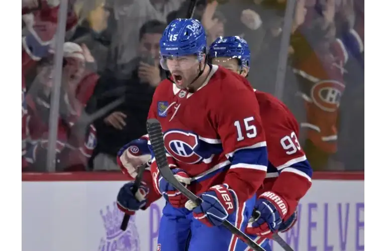 Alex Newhook celebrating a goal on the ice
