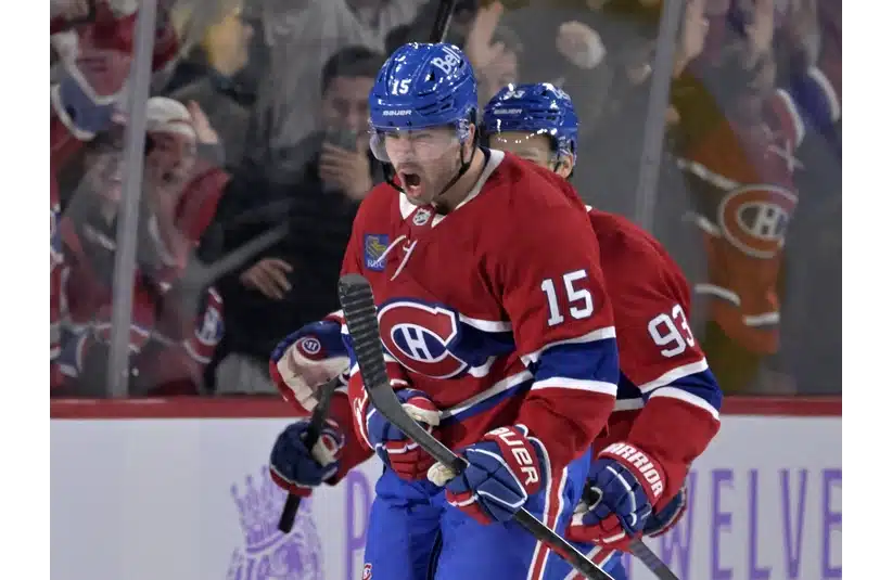 Alex Newhook celebrating a goal on the ice