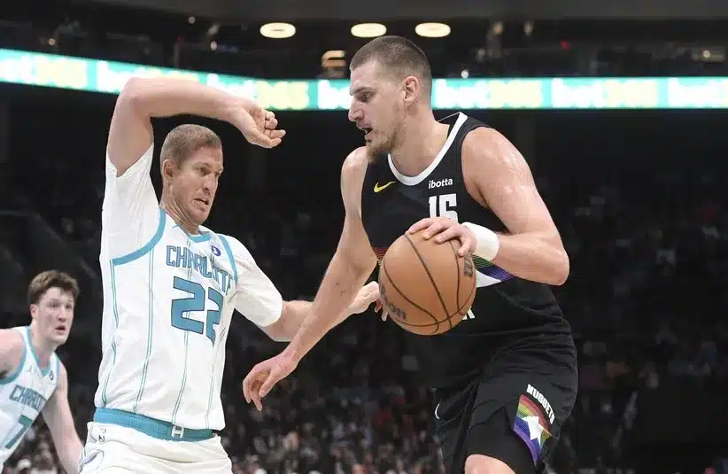 Denver Nuggets center Nikola Jokic (15) looks to drive past Charlotte Hornets center Mason Plumlee