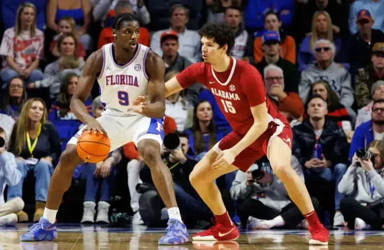 Florida Gators center Rueben Chinyelu (9) posts up against Alabama Crimson Tide center Noah Williamson (15)