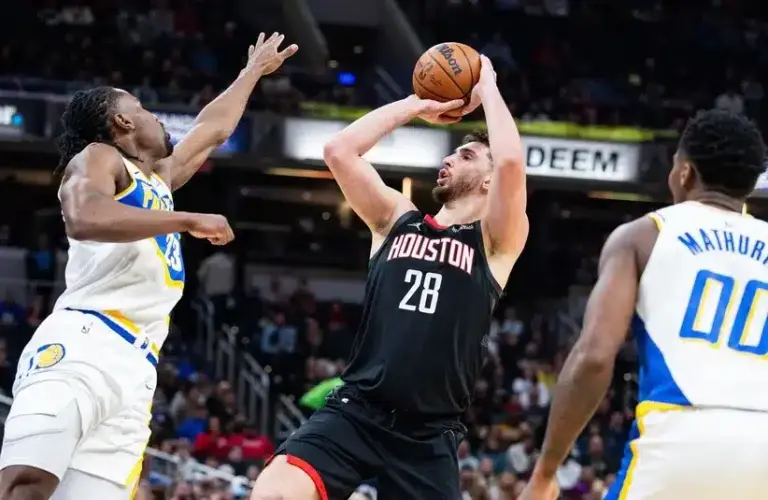Houston Rockets center Alperen Sengun (28) shoots the ball while Indiana Pacers guard/forward Aaron Nesmith (23) defends.