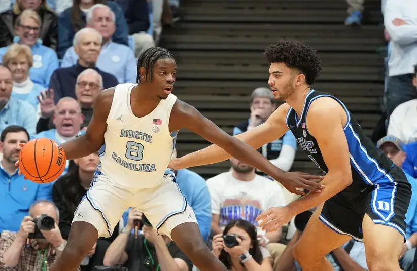 North Carolina Tar Heels forward Caleb Wilson (8) with the ball as Duke Blue Devils forward Cameron Boozer (12) defends in the first half.