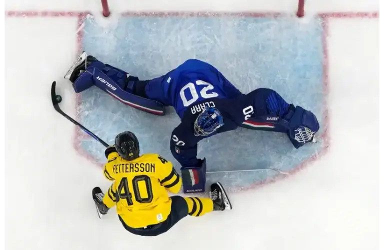 Damian Clara of Italy sprawls out to make a save against Elias Pettersson