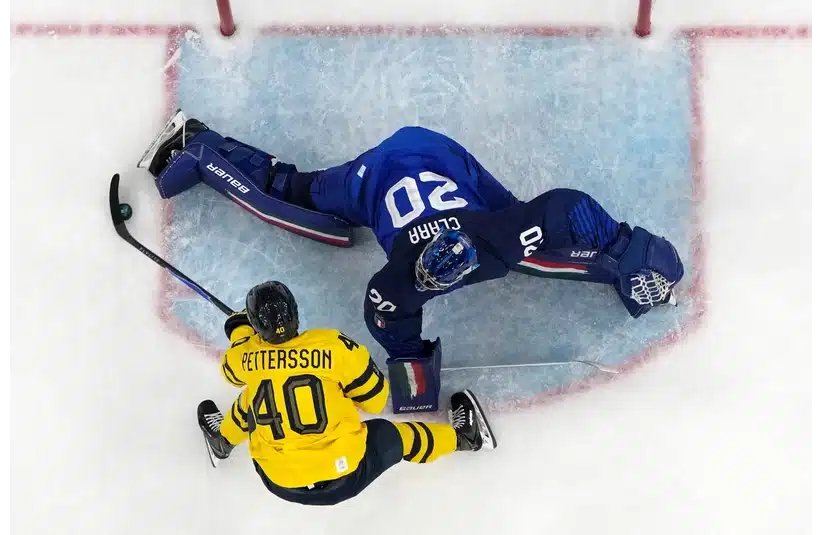Damian Clara of Italy sprawls out to make a save against Elias Pettersson