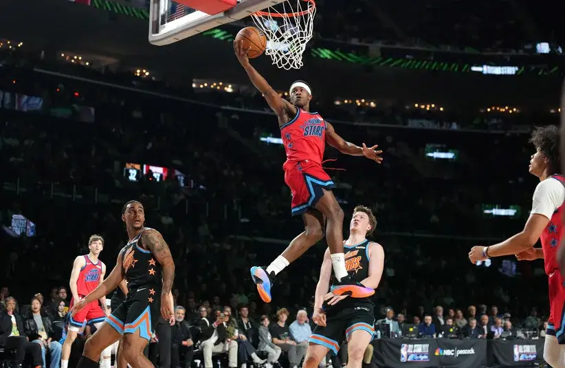 Team Vince guard VJ Edgecombe (77) of the Philadelphia 76ers shoots against Team T-Mac guard Kon Knueppel (7) of the Charlotte Hornets during an NBA All Star Rising Stars game at Intuit Dome.