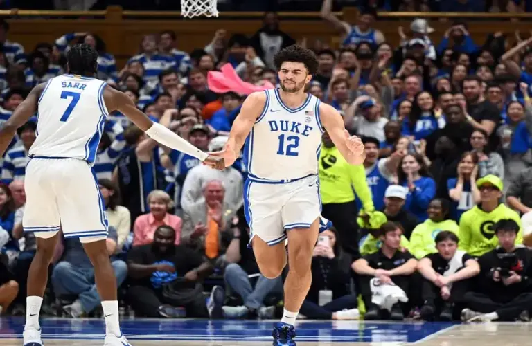 Duke Blue Devils forward Cameron Boozer (12) is greeted by forward Dame Sarr (7) after scoring a basket during the first half against the Clemson Tigers.